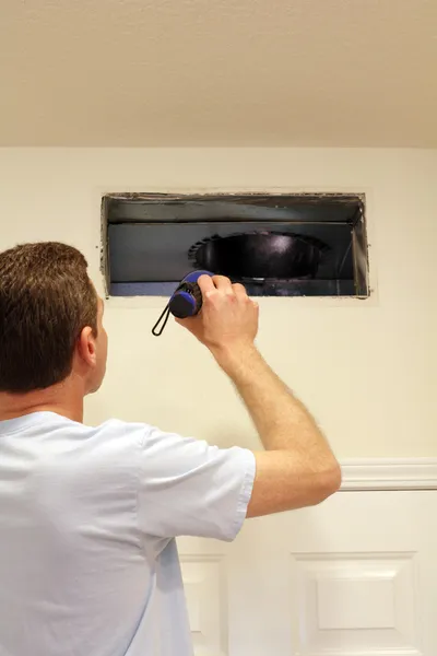 Air duct cleaning professional at work